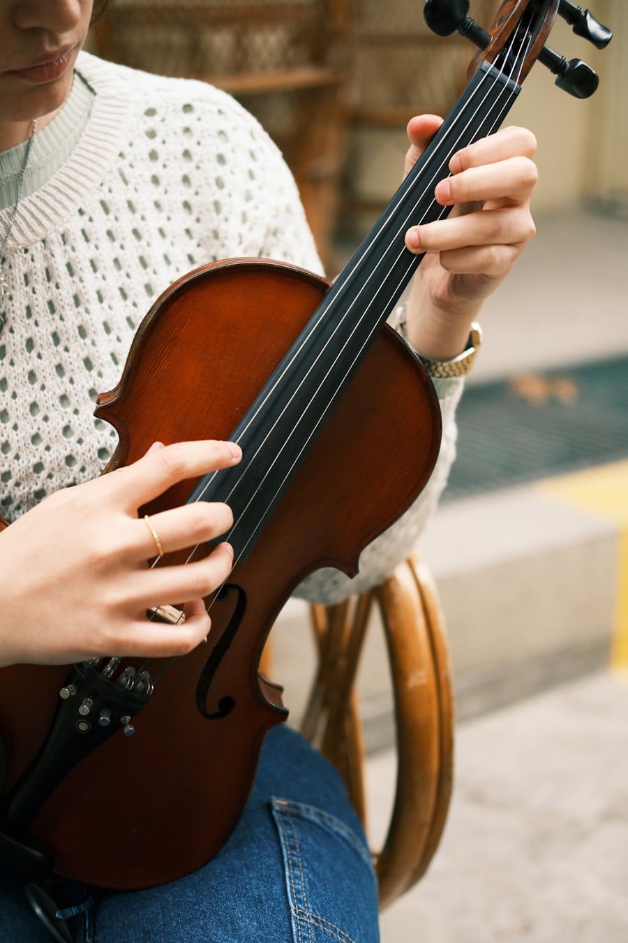A violinist plucking the strings of a violin by hand, with no bow in use